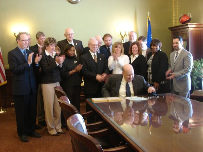 group of business people signing document clapping
